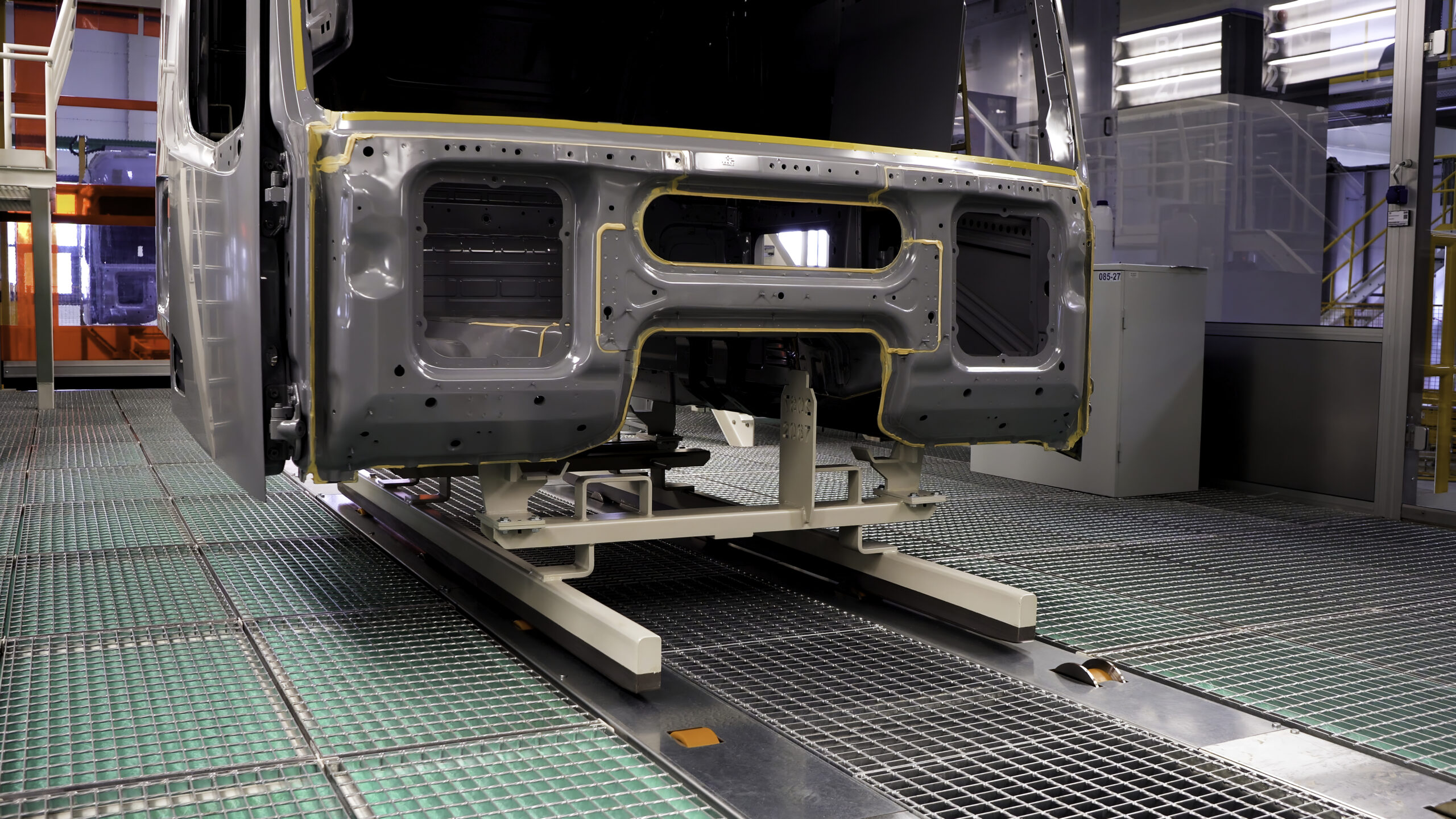 Process of truck car automated assembly, machine industry. Scene. Metal new parts of truck cars at the factory